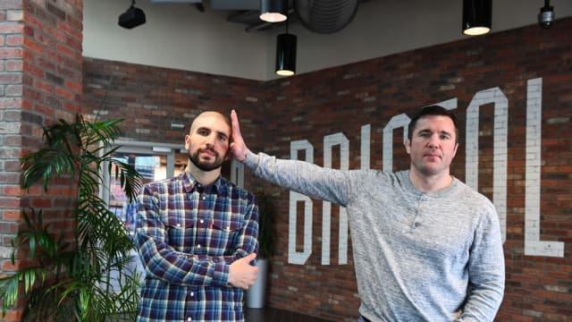Chael Sonnen & Ariel Helwani pose for the ESPN camera.